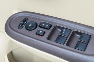 car interior details of door handle with windows controls and adjustments photo