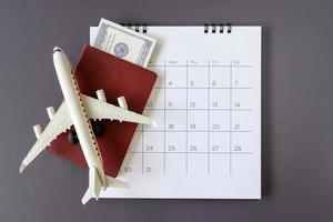 Airplane model with paper calendar. plan for trip photo