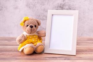 teddy bear with Picture frame on table wooden. Valentine's Day celebration photo