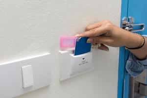 Asian women hand hold card for door access control scanning key card to lock and unlock door. photo