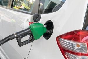 Fuel nozzle to add fuel in car at gas station photo