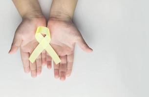 child holding gold ribbon. Cancer awareness photo