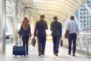 Group of business people walking at street photo