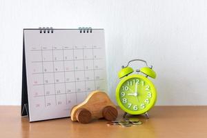 Calendar and car on table. Day of buying or selling a car or payment for rent or loan or repair photo