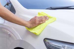 man cleaning car with microfiber cloth photo