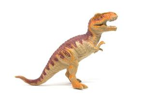 Plastic Tyrannosaurus toy isolated on white background photo