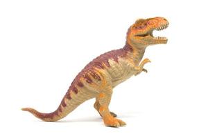 Plastic Tyrannosaurus toy isolated on white background photo