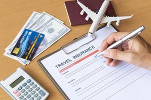 Travel  insurance form with model and policy document photo