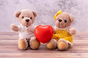 couple teddy bear with heart on table wooden. Valentine's Day celebration photo