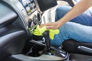 man cleaning car with microfiber cloth photo