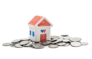 house and coins on white background photo