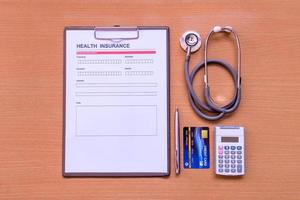 Health insurance form with model and policy document photo