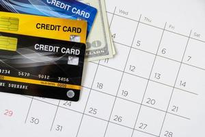 Calendar with days and Credit card on table. shopping concept photo