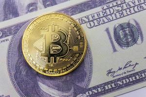 Golden bitcoin coin on us dollars