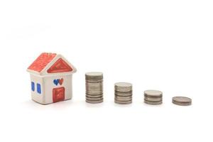 house and coins on white background photo