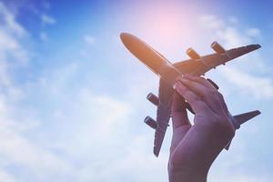 Small kid hands holding airplane photo