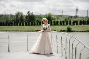 The bride holds a wedding bouquet in her hands And spins. photo