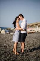 Young couple walking on the background of the sea on the island of Santorini photo