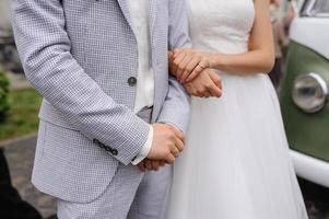 Overstretched hands of the bride and groom.... photo