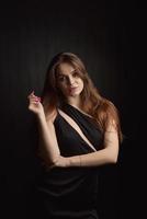 Beautiful Woman in Black Dress on black Backgound photo