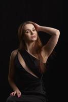 Beautiful Woman in Black Dress on black Backgound photo