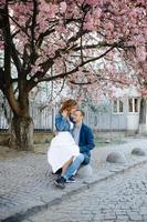 couple in love in a blooming Apple orchard lying on the blanket photo