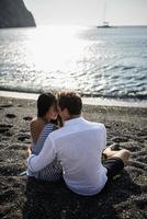 Young couple walking on the background of the sea on the island of Santorini photo