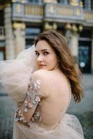 Portrait of a lovely young girl in a lush dress walking around the park and the Grand Palace photo