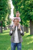 Father hugs his little daughter tightly. photo