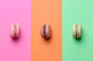 pink, brown and green macaroon on background in three matching colors photo