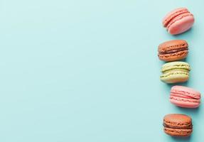 turquoise background with five macarons on the right side photo