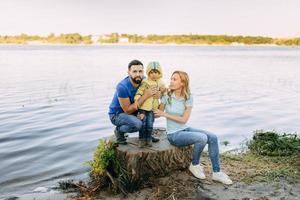 Parents play in the park with their son photo