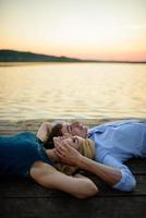 Man and woman on the pier near the lake. photo