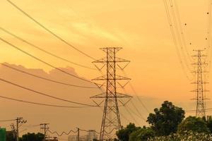 High voltage electricity pylon system, Electricity transmission power lines at sunset photo