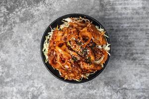 Top view Korean food, stir-fried pork with gochujang sauce on rice. photo