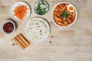 Top view raw ingredient for making Tteteokbokki Spicy Rice Cakes Korean street food on the wooden table with copy space. photo