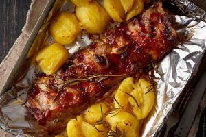 Spicy barbecue pork ribs and crushed smashed potatoes. Slow cooking recipe. photo