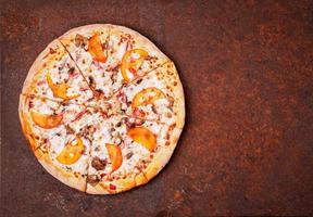 round Italian pizza bbq on a rusty metal desk top view, empty space for text. photo