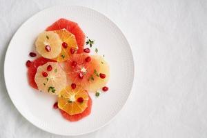 Bright mix of citrus fruits, vertical. Salad of mix sliced round slices of red and white grapefruit photo