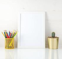 Mockup with clean white frame, colored pencils and succulent on white background. Concept for creativity, drawing. photo