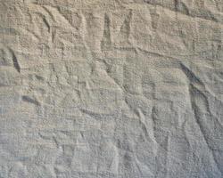 Natural linen texture background. Crumpled fabric of gray color, rough texture photo