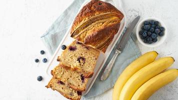 Homemade Banana bread. Baked cake. Top view, white table. photo