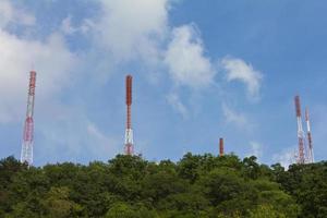 Telecommunications mast on many forests. photo