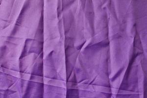 Purple fabric with creased crumpled. photo