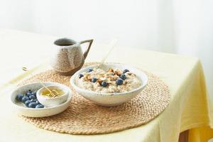 Breakfast, oatmeal porridge with berries and nuts, healthy food, proper nutrition.