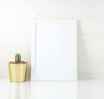 Mockup with clean white frame and succulent on white background photo