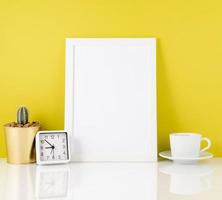 Blank white frame, clock, succulent,mug with tea or coffee again photo