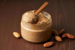 almond butter, raw food paste made from grinding almonds into nut butter, side view photo