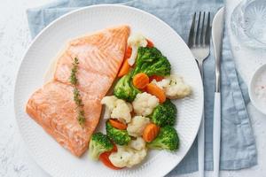 Steam salmon and vegetables, Paleo, keto, fodmap, dash diet. Mediterranean food with fish photo