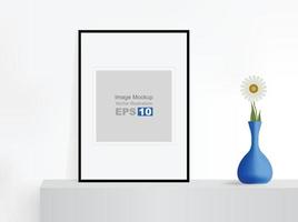 Image frame mockup isolated on cubical cabinet stand with blue flower vase vector